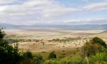 A stunning panoramic view of Ngorongoro Crater in Tanzania, showcasing its vast savannah and natural beauty.